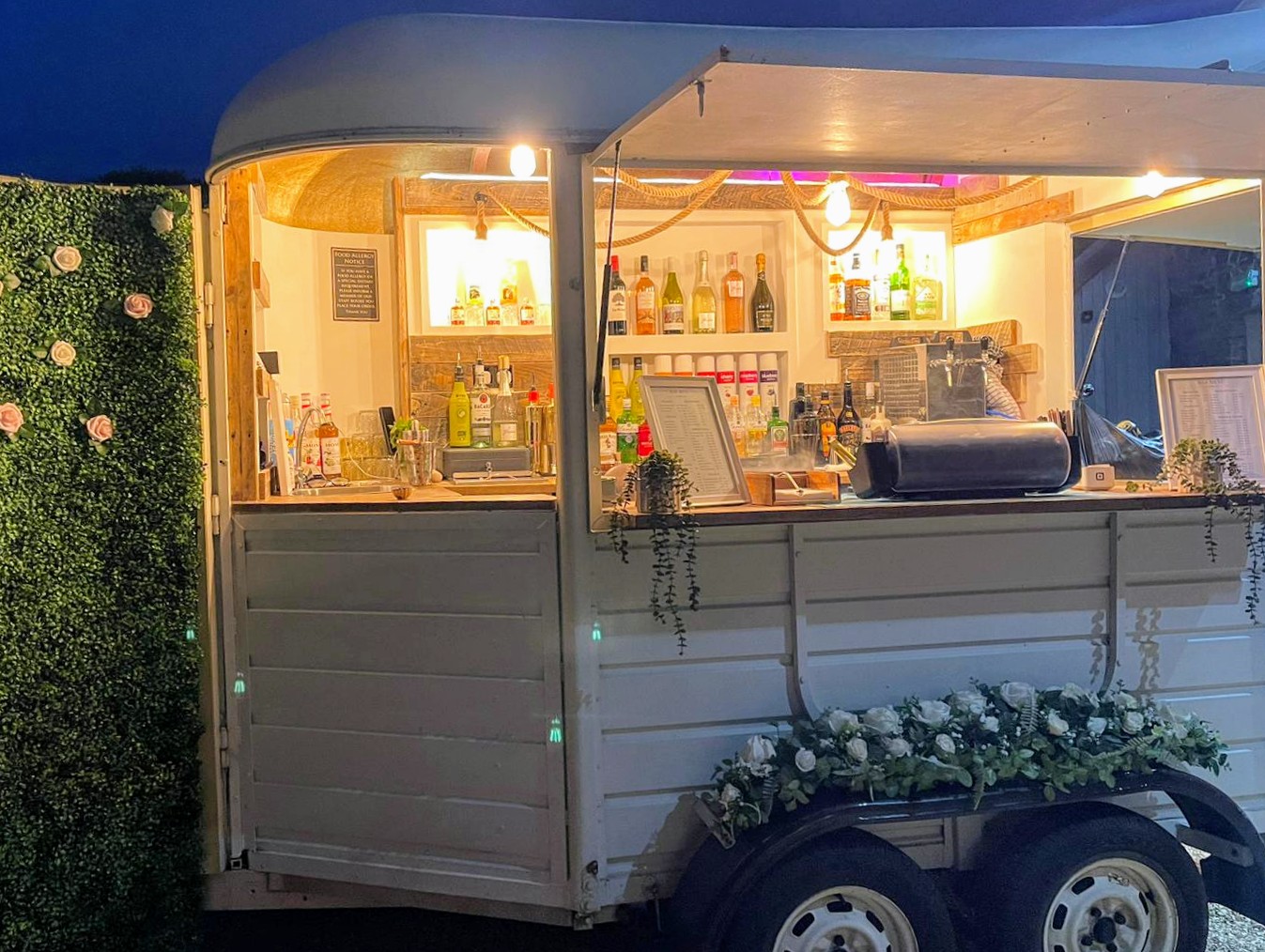 The White Oak horsebox bar illuminated for evening service