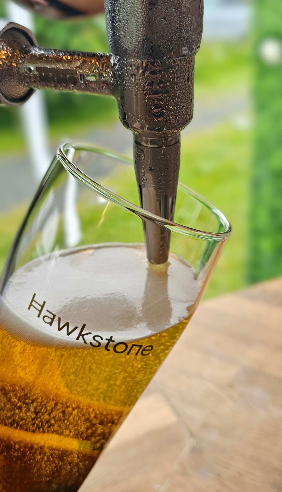 A cold glass of Hawkstone being poured at the bar