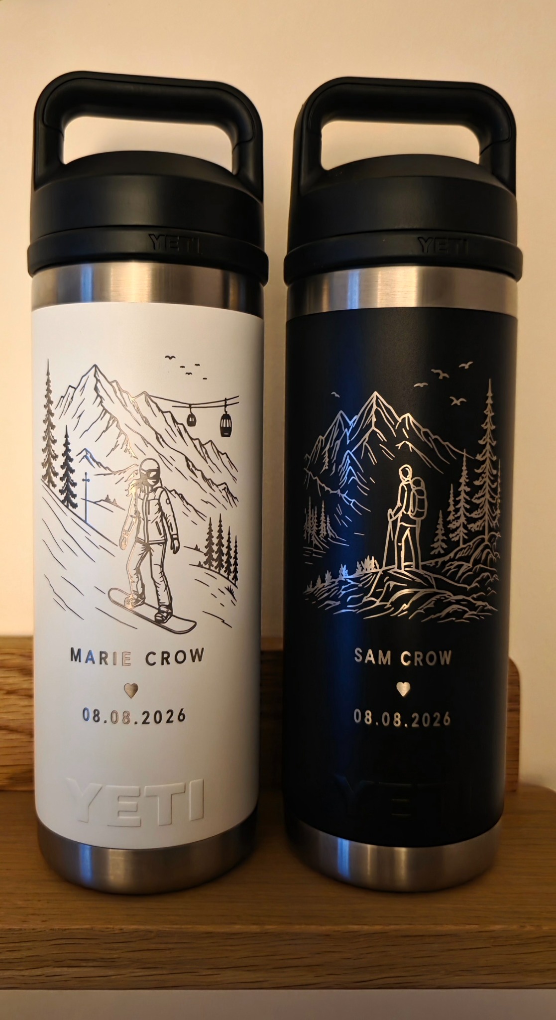 Matching YETI bottles engraved with personalised mountain and adventure scenes for a wedding